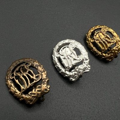 Three miniatures of DRL sport badges.