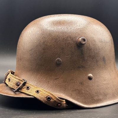Genuine Austro-Hungarian M17 steel helmet of the First World War. Wartime web chinstrap, complete original leather liner, Isonzo-braun finish. With a named US veteran bring back provenance, France, 1918.